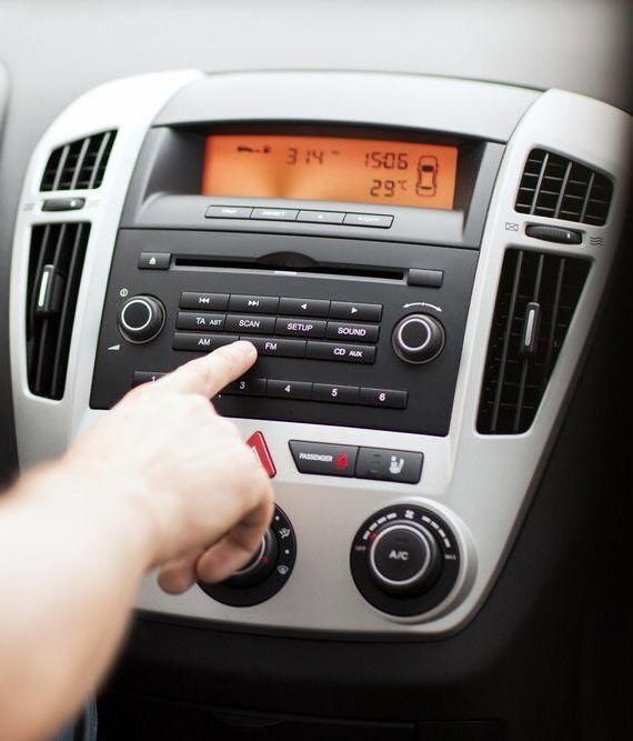 A Person Is Pressing A Button On A Car Radio — Autofit88 Auto Electrics In Ciccone, NT