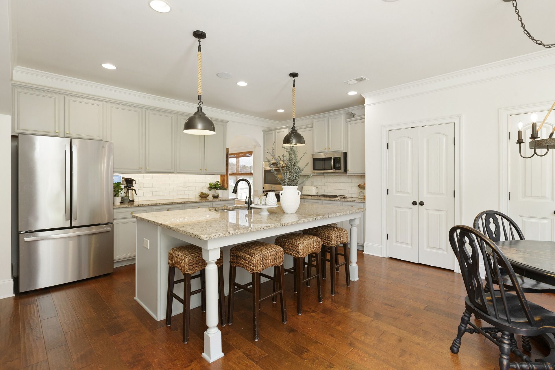 Bright kitchen with island seating and stainless appliances for kitchen remodeling in El Mirage, AZ