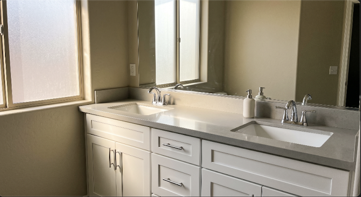 White bathroom vanity with double sinks and chrome faucets for bathroom remodeling in Peoria, AZ