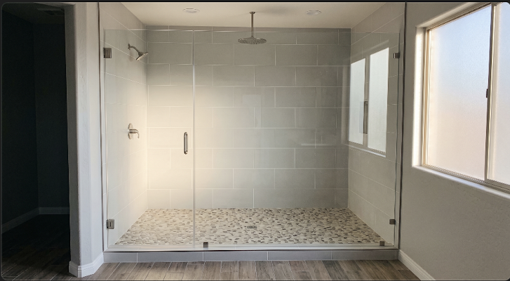 Modern walk-in shower with gray tile and glass door for bathroom remodeling in Sun City, AZ