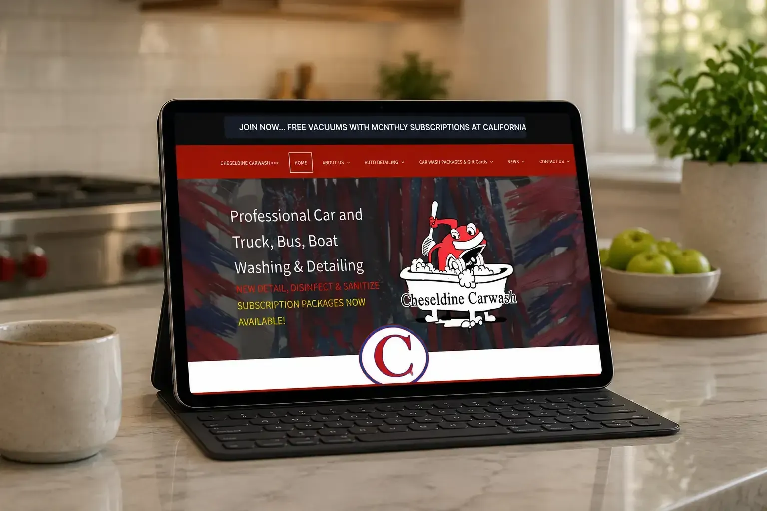 Laptop displaying a website on a kitchen counter, with a red-and-black page and coffee mug nearby
