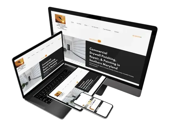 Laptop and desktop monitors showing a modern website design with black and white layout