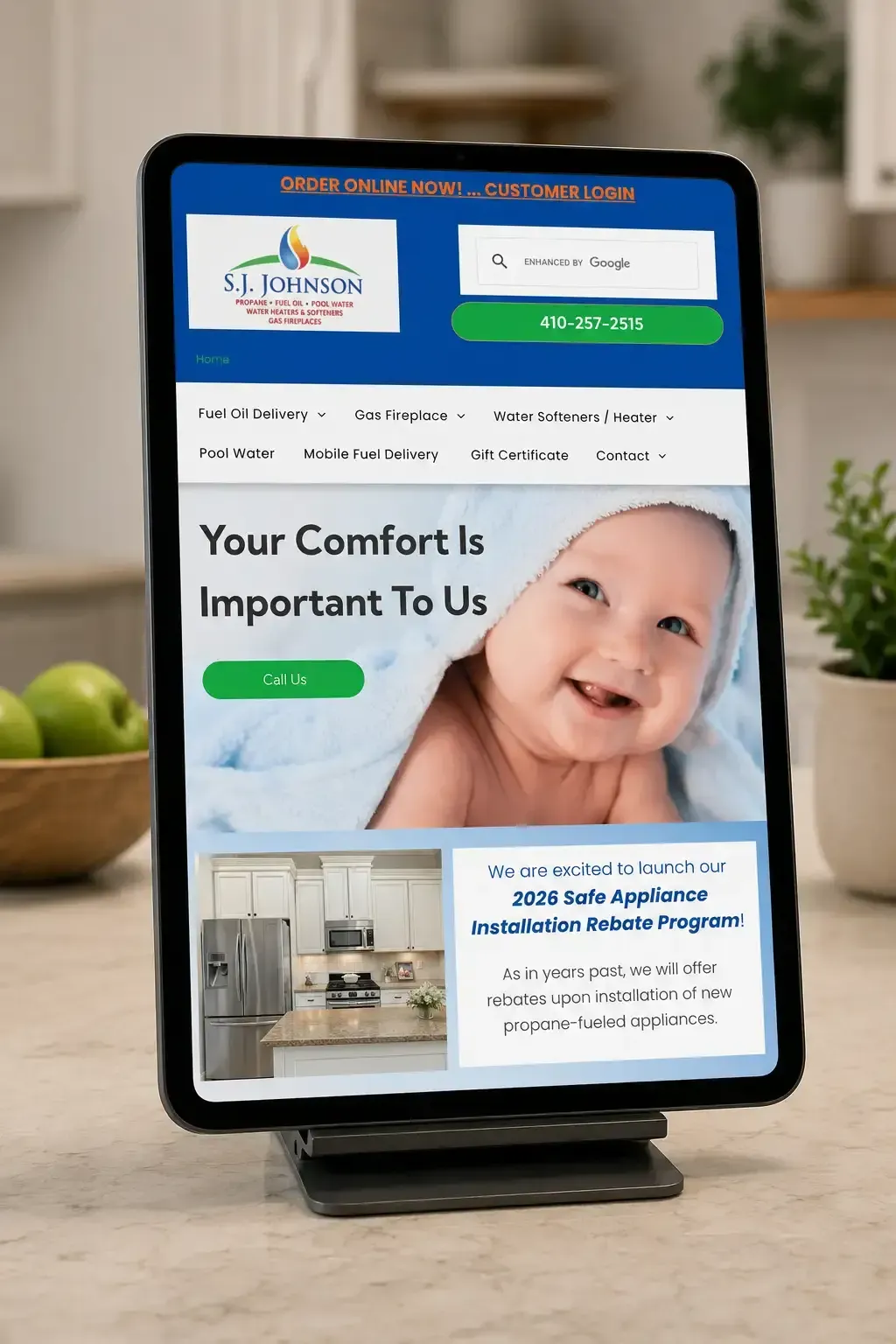 Tablet displaying a real estate ad with a smiling baby, blue-and-white layout, and home interior photo