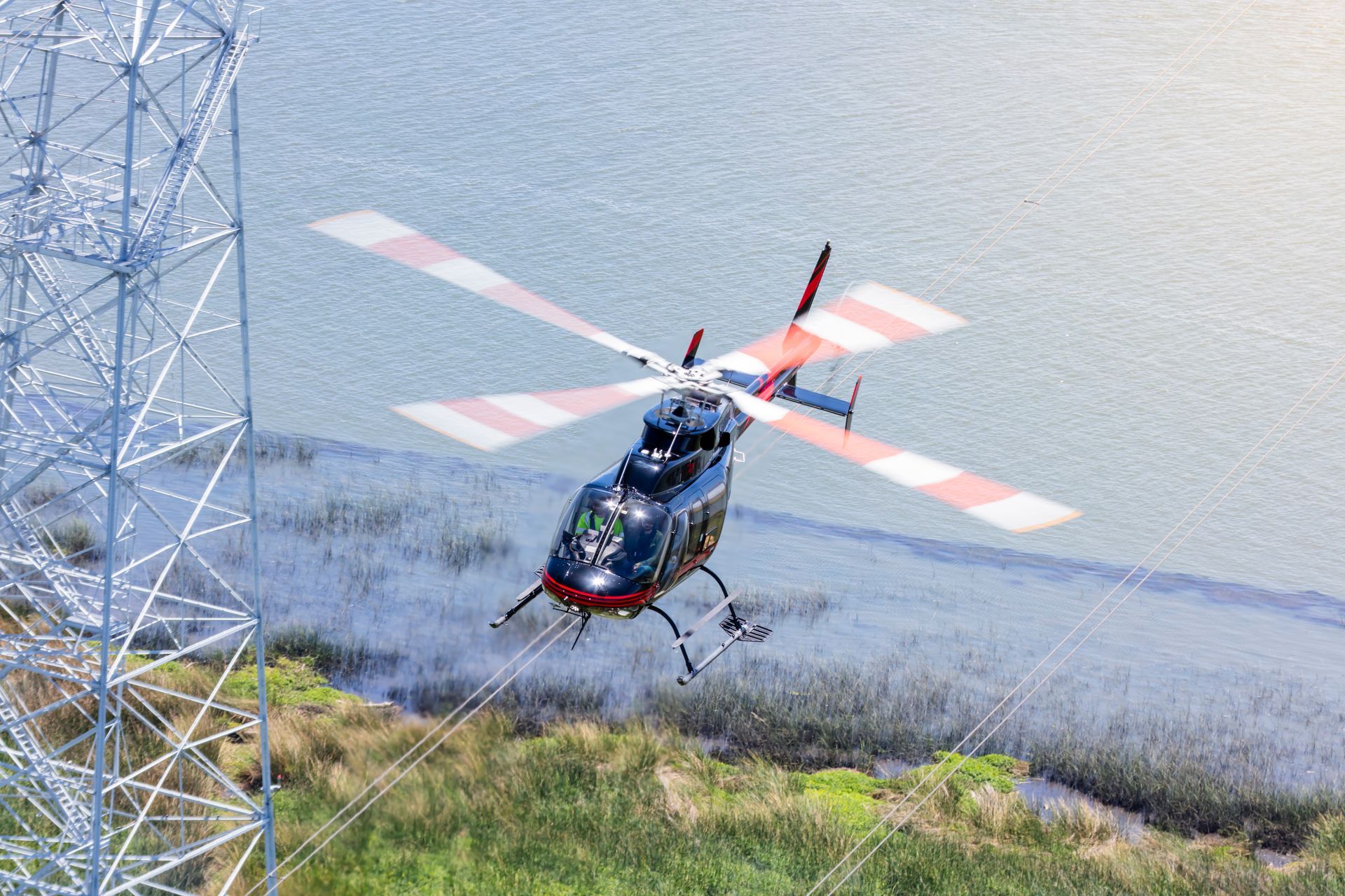 A helicopter is flying over a body of water.