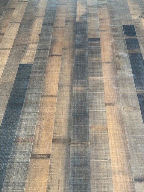 Striped wood-pattern floor or rug in muted tan, gray, and blue tones