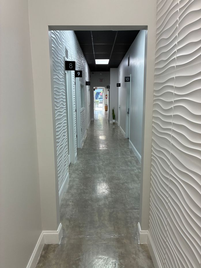 Interior hallway of salon suites for rent in North Miami with private beauty studio doors