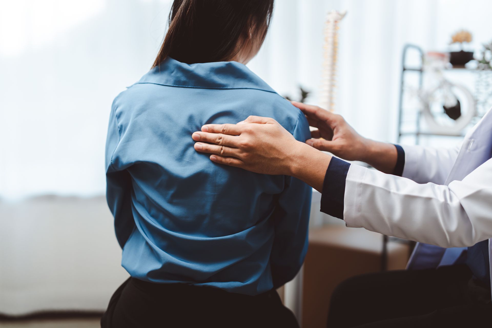 Chiropractor reviewing a patient's postural assessment during a consultation.