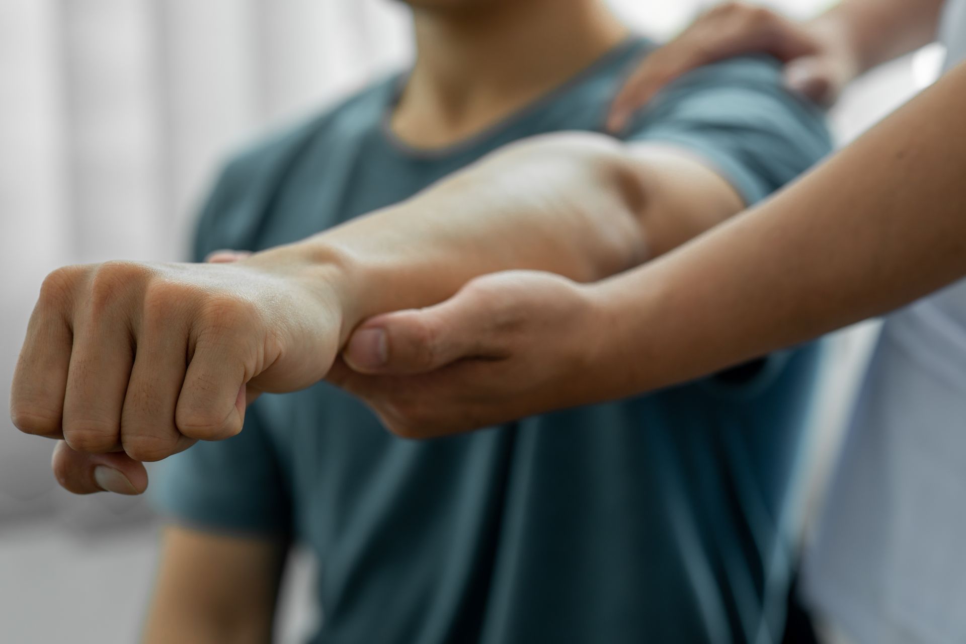 Two people extending clenched fists toward each other in a teamwork gesture