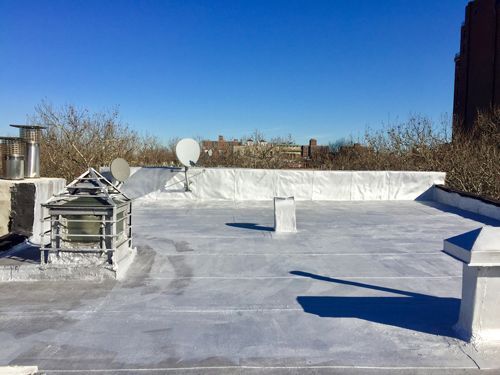 A Roof With A Chimney And Satellite Dishes On It — Pittsfield, MA — ML Contracting