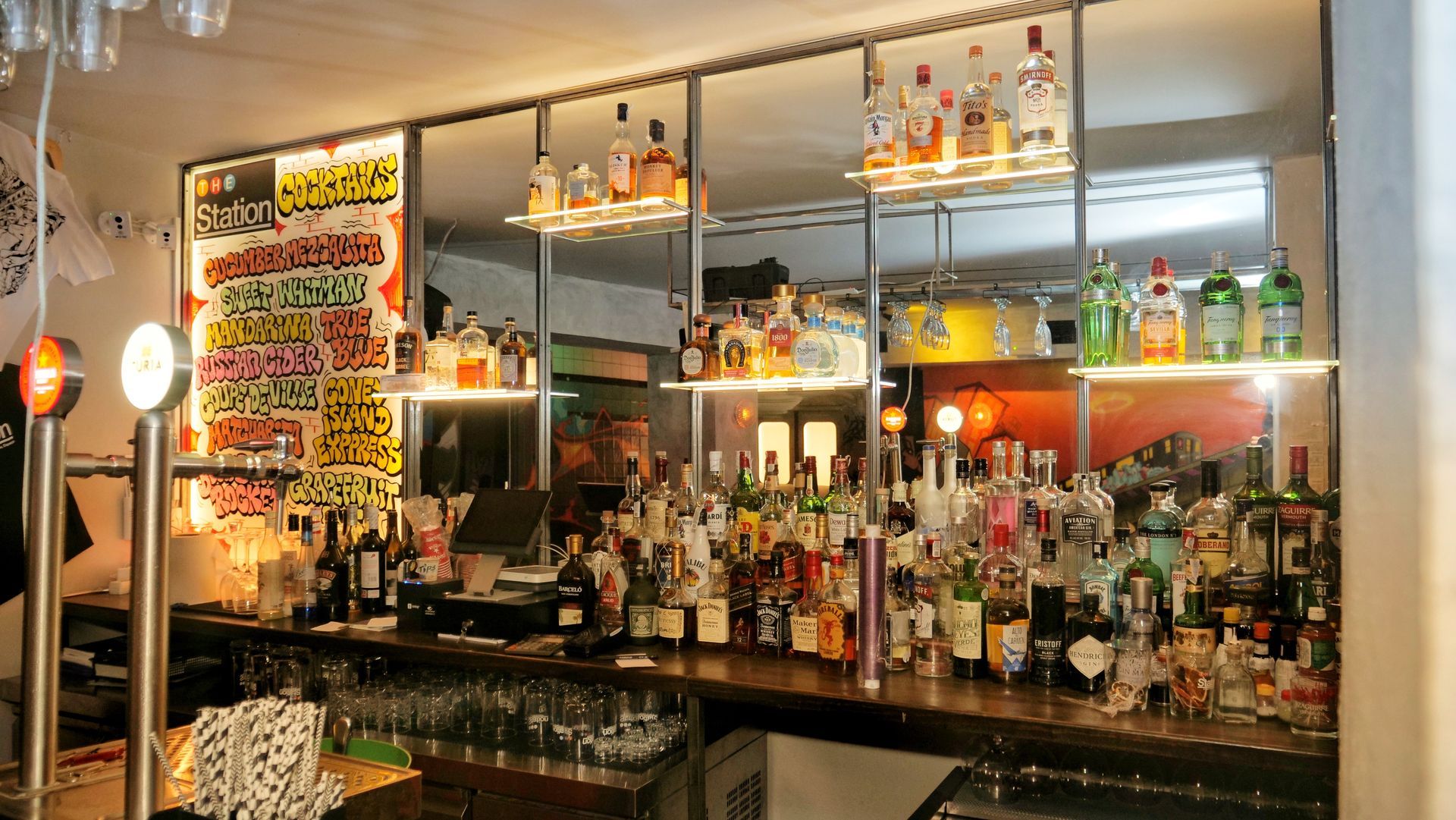 A bar filled with lots of bottles and glasses