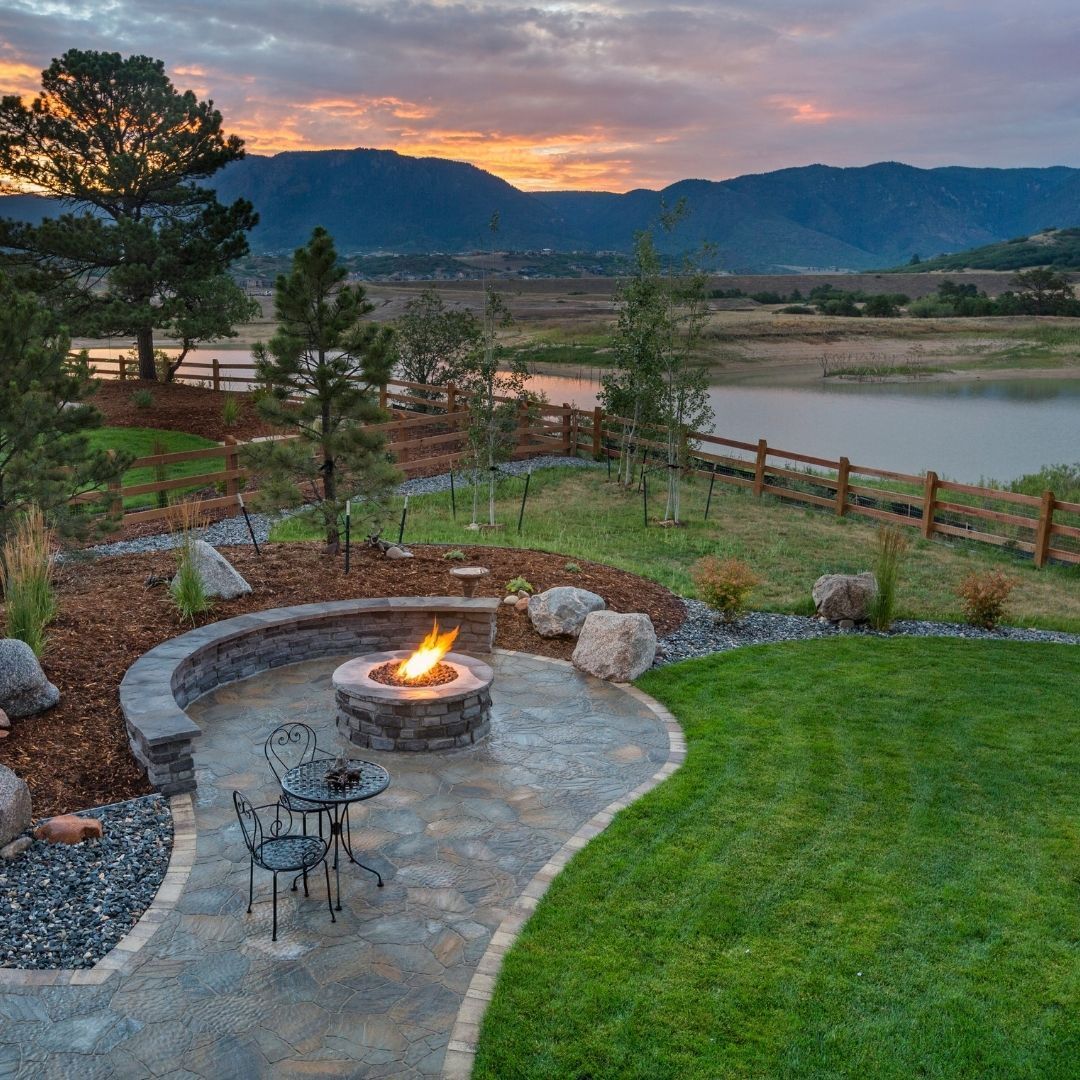 There is a fire pit in the middle of the backyard.