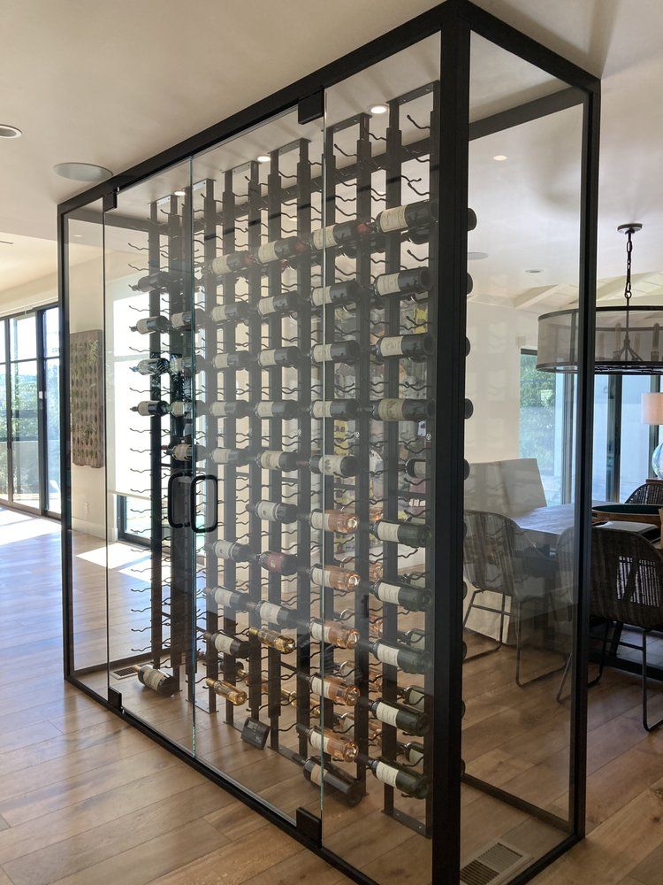 Modern room divider with black metal frame and geometric shelving in a bright interior room