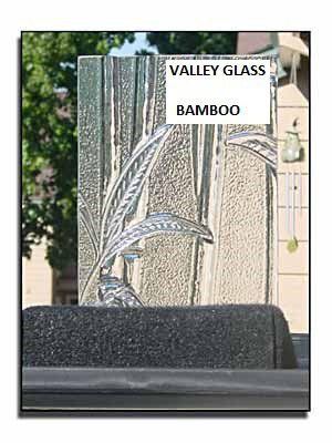 Decorative glass panel with bamboo design and “Valley Glass Bamboo” text, shown behind a dark bench