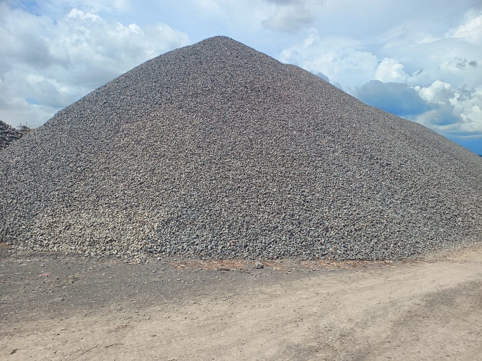 Montón de grava gris contra un cielo nublado.