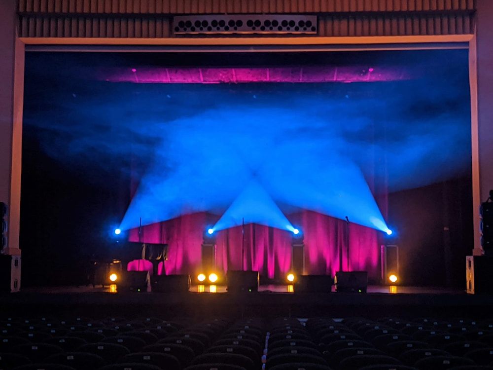 A Stage With Blue and Purple Lights on It — Inspired Audio Visual in Coffs Harbour, NSW