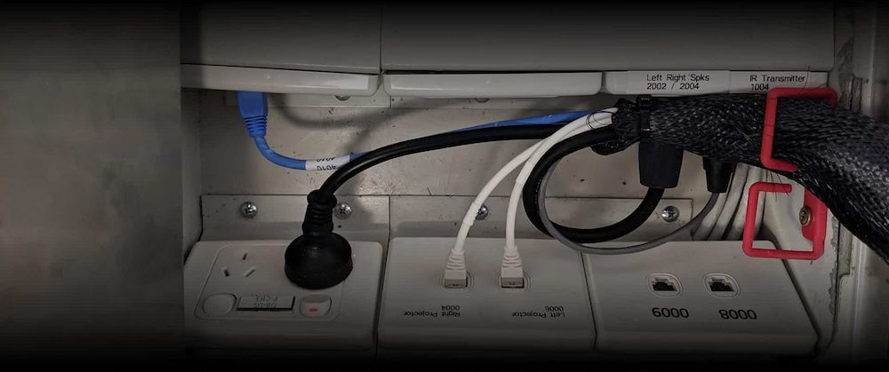 A Bunch of Wires Are Plugged Into a Wall Socket — Inspired Audio Visual in Coffs Harbour, NSW