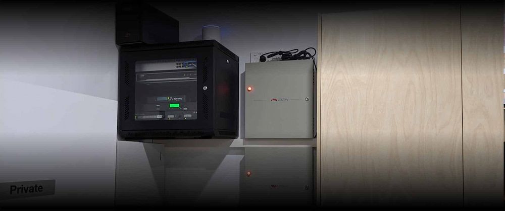 A Computer is Sitting on a Wall Next to a Refrigerator — Inspired Audio Visual in Coffs Harbour, NSW