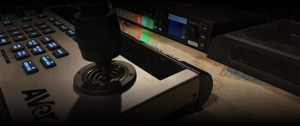 A Remote Control is Sitting on a Table Next to a Keyboard — Inspired Audio Visual in Coffs Harbour, NSW