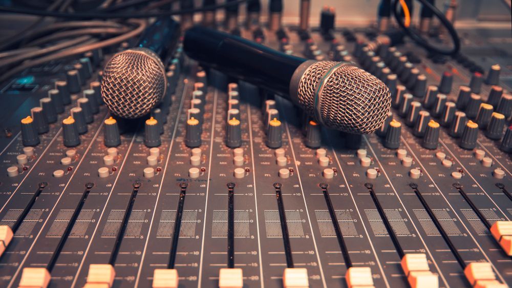Two Microphones Are Sitting on Top of a Sound Board — Inspired Audio Visual in Coffs Harbour, NSW