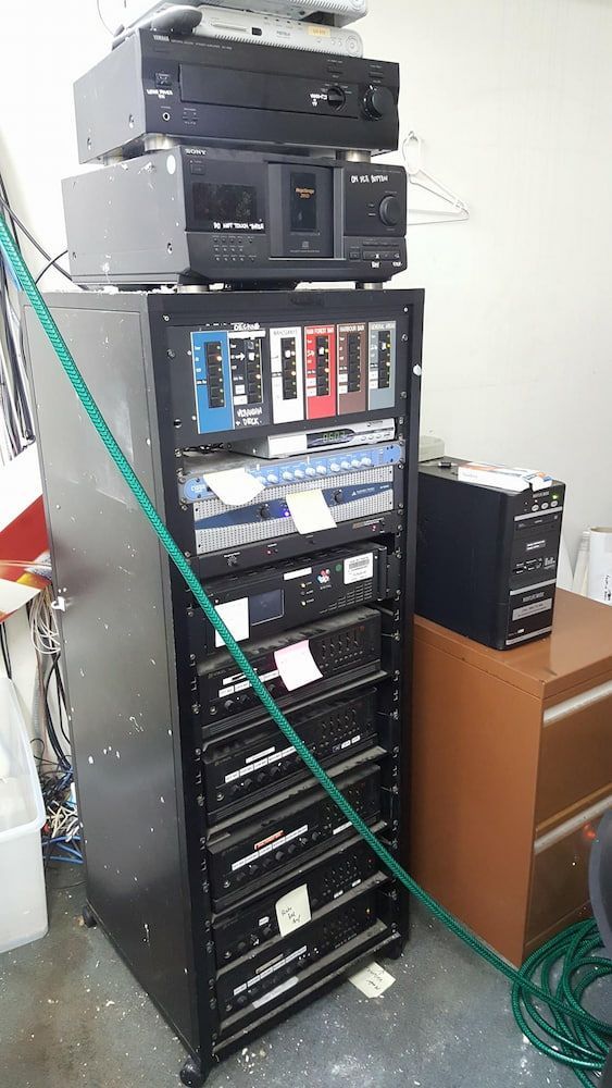 A Bunch of Electronics Are Stacked on Top of Each Other on a Rack — Inspired Audio Visual in Grafton, NSW