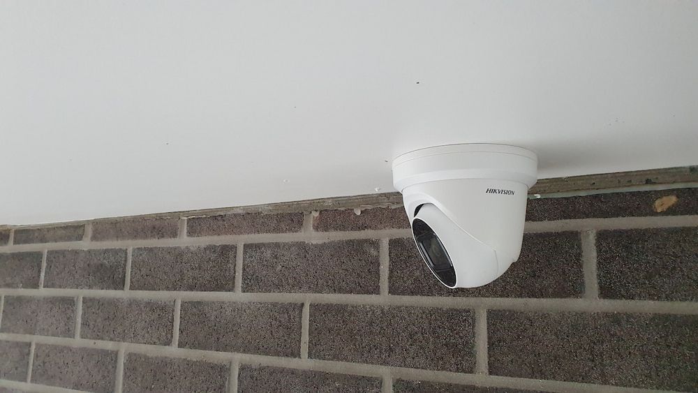 A Security Camera is Mounted to the Ceiling of a Brick Wall — Inspired Audio Visual in Port Macquarie, NSW