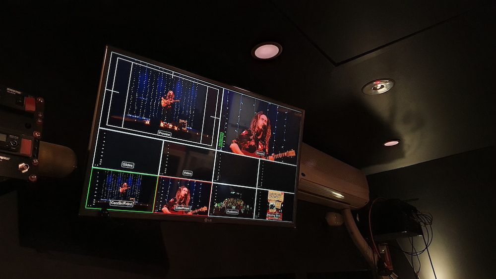 A Television is Hanging From the Ceiling in a Dark Room — Inspired Audio Visual in Port Macquarie, NSW