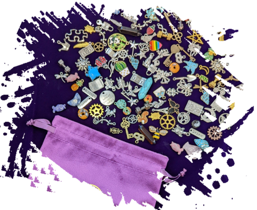 Decorative tin with lid open and many different charms inside and multiple closed tins of different designs and colors 