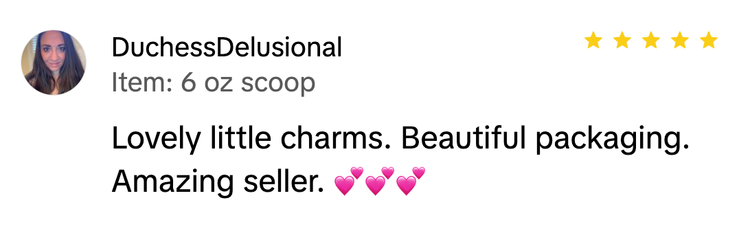 Customer review screenshot praising “Lovely little charms” and “Beautiful packaging” with five stars and pink hearts.
