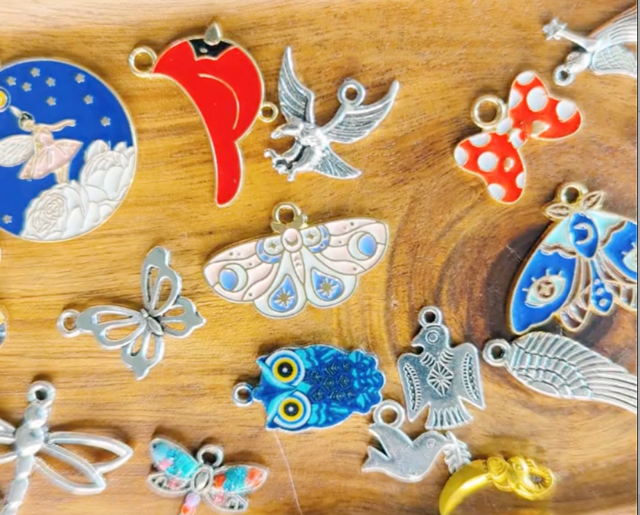 Collection of colorful charms on a wooden tray to be used for charm divination