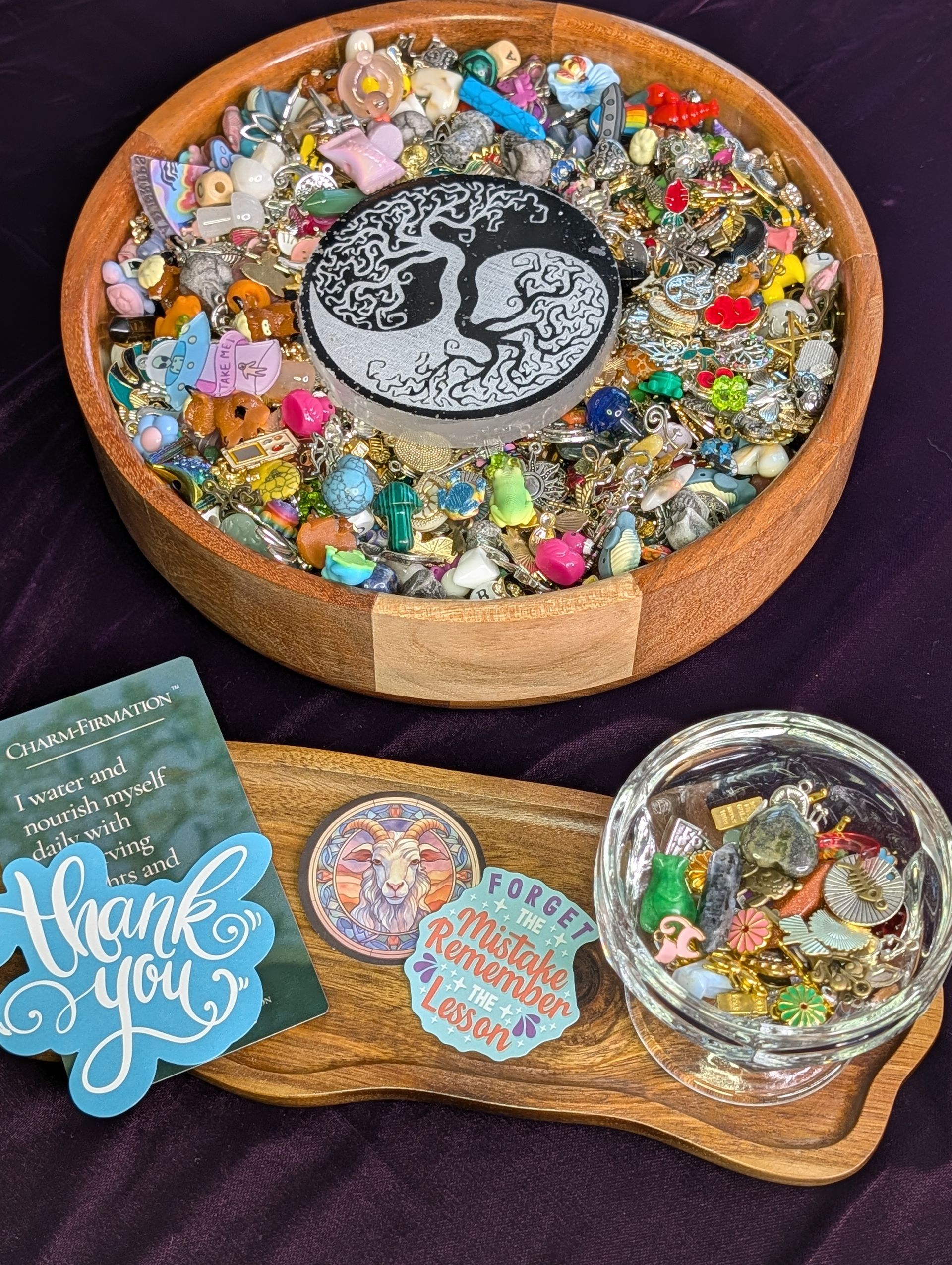 Small tray of colorful trinkets and gems with a round yin-yang stone, plus a thank-you card and dish.