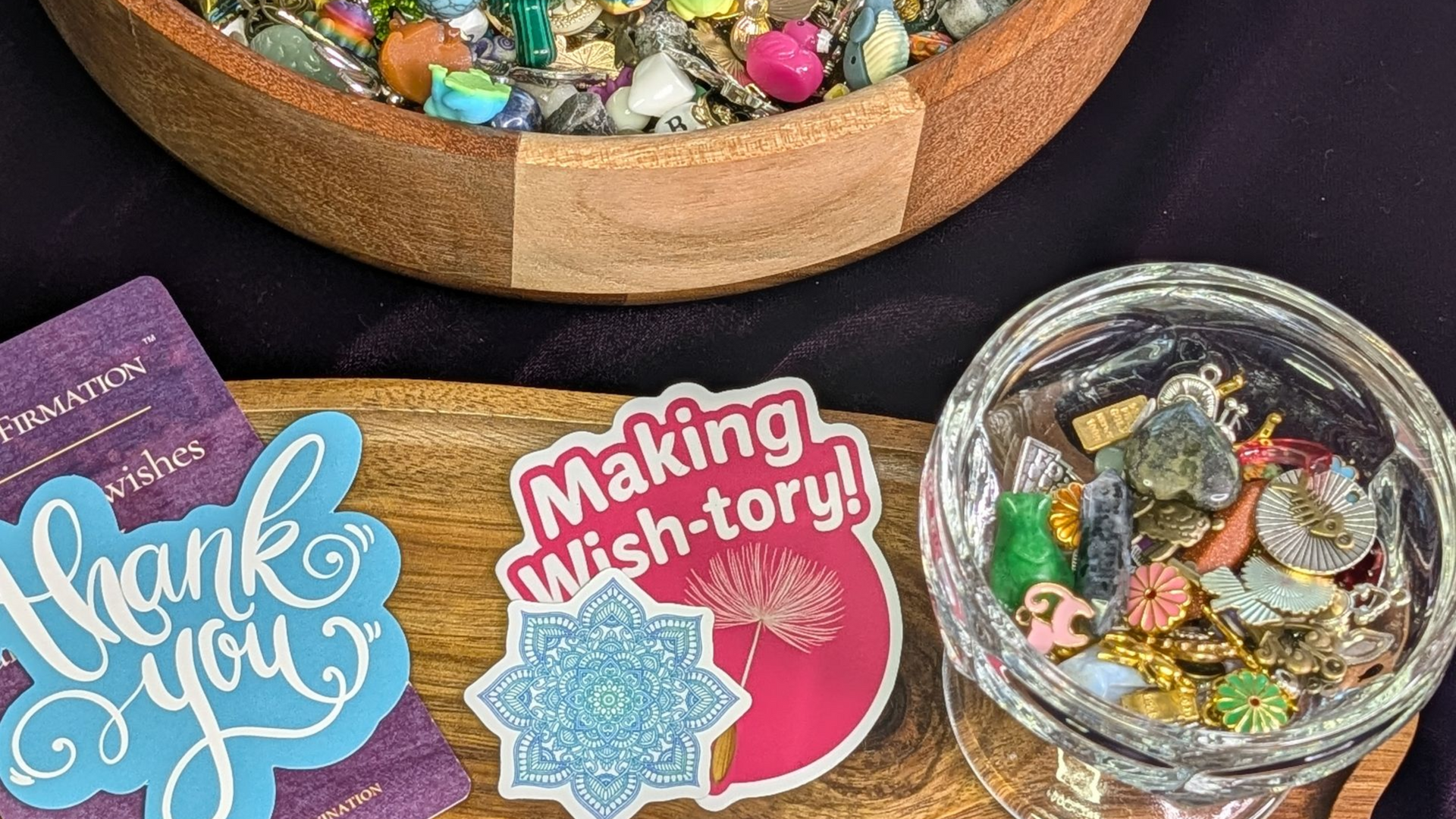 Colorful handmade thank-you and “Making This-tory!” badges beside bowls of assorted craft pieces