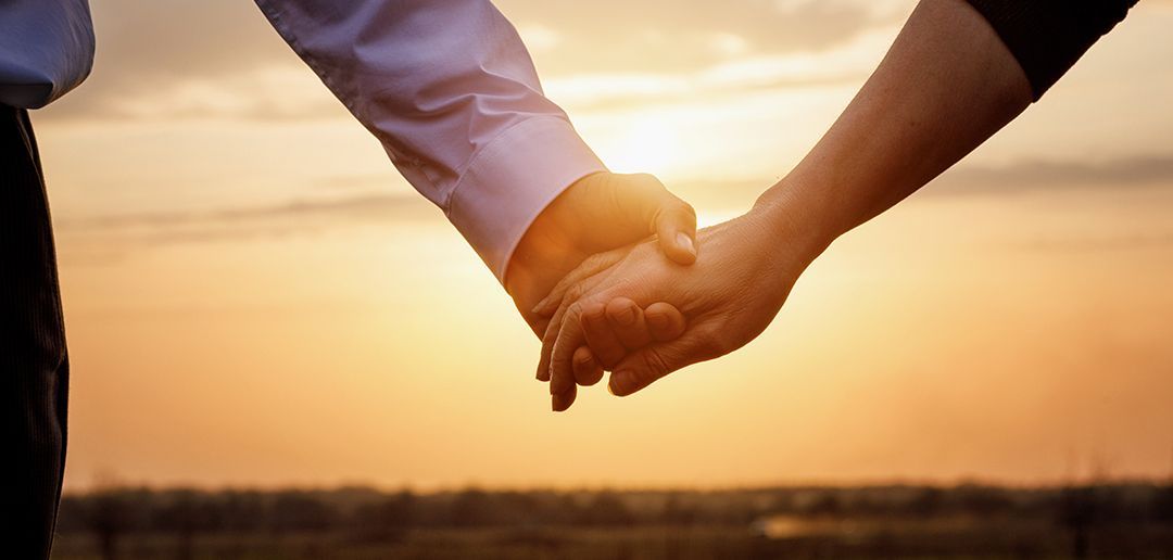 a woman is holding the hand of an older woman .