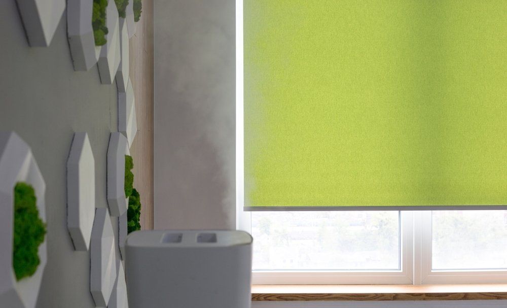 Roller Blinds Closeup On The Window In The Interior — Coordinations Blinds & Awnings in Falls Creek, NSW