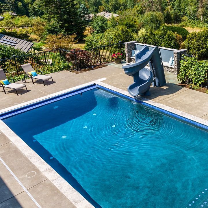 A Large Swimming Pool With a Slide in the Middle - Madison, AL - Valley Pools