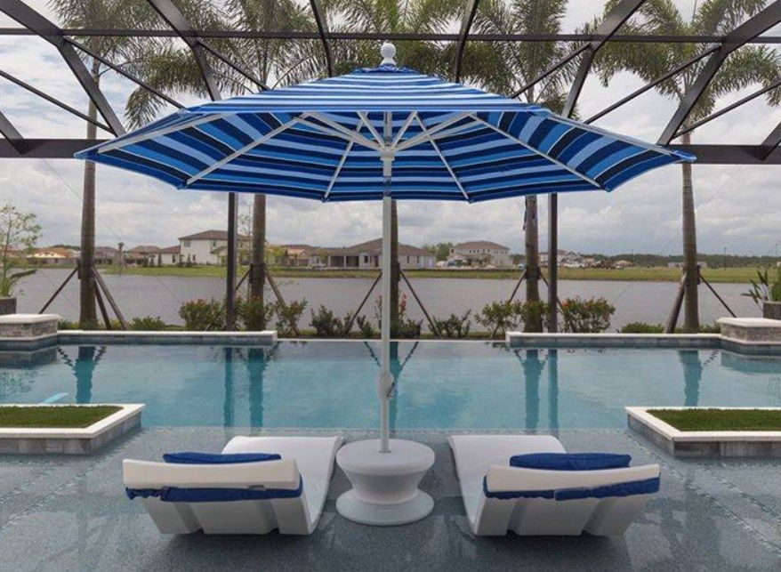 A Blue and White Striped Umbrella Near the Swimming Pool - Madison, AL - Valley Pools