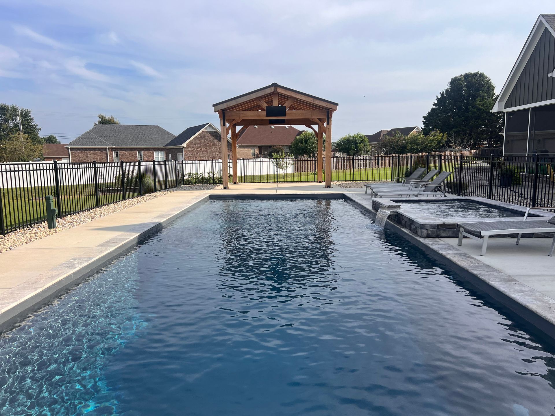 There is a large swimming pool with a gazebo in the background. - Madison, AL - Valley Pools