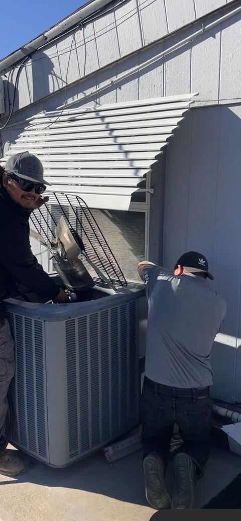 Air-Exx technicians servicing a commercial condenser