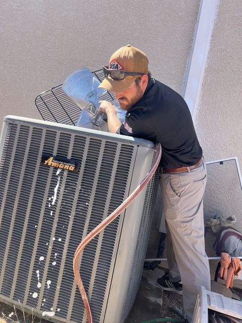 Condenser coil packed with desert dust being cleaned