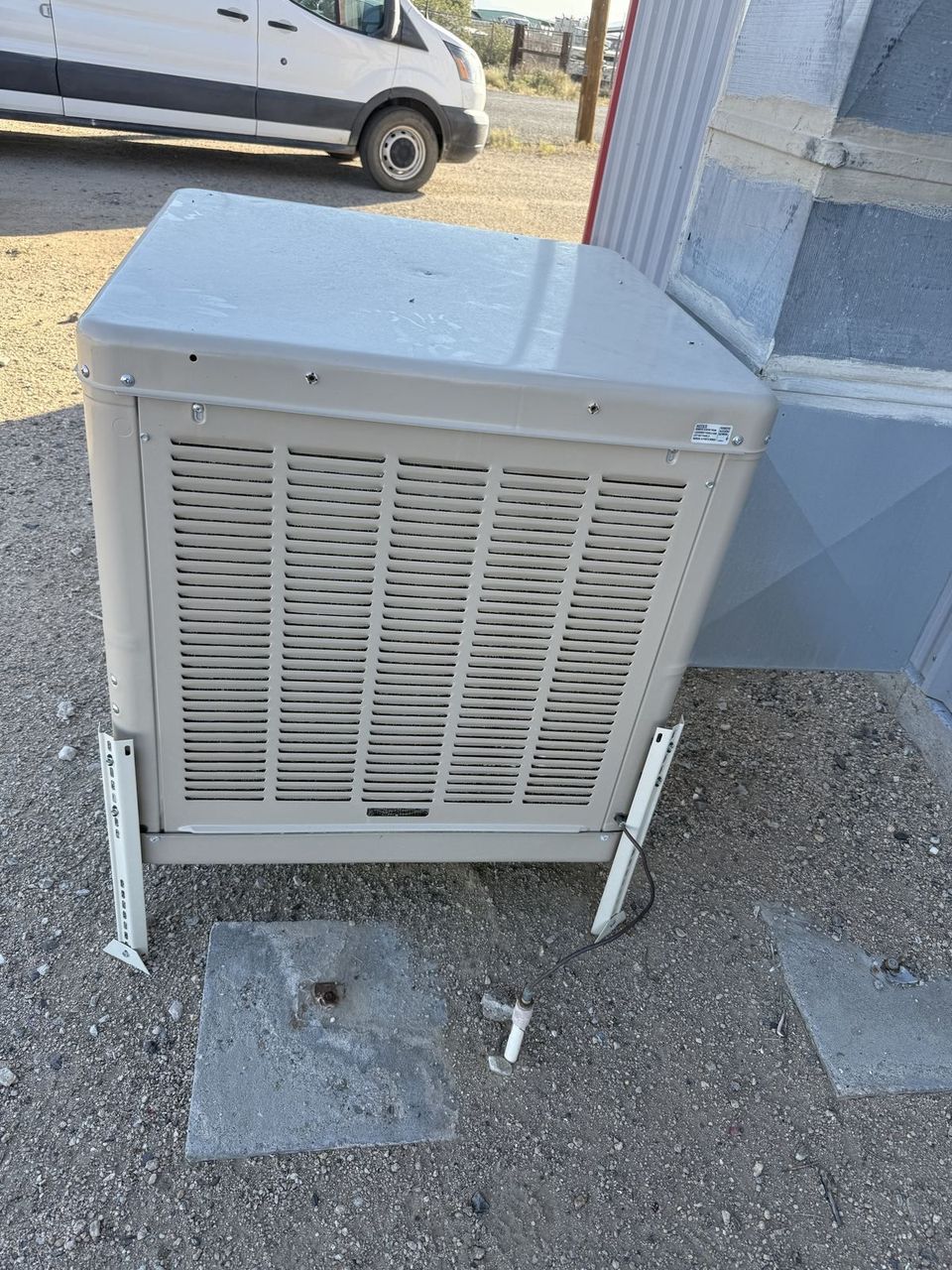 Air-Exx technician installing an evaporative swamp cooler in Mohave County, Arizona