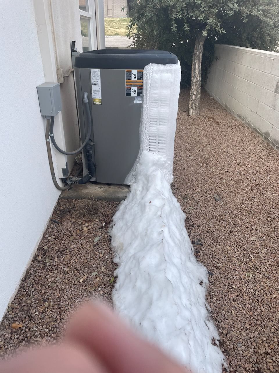 Heat pump condenser packed with ice and snow in northern Arizona