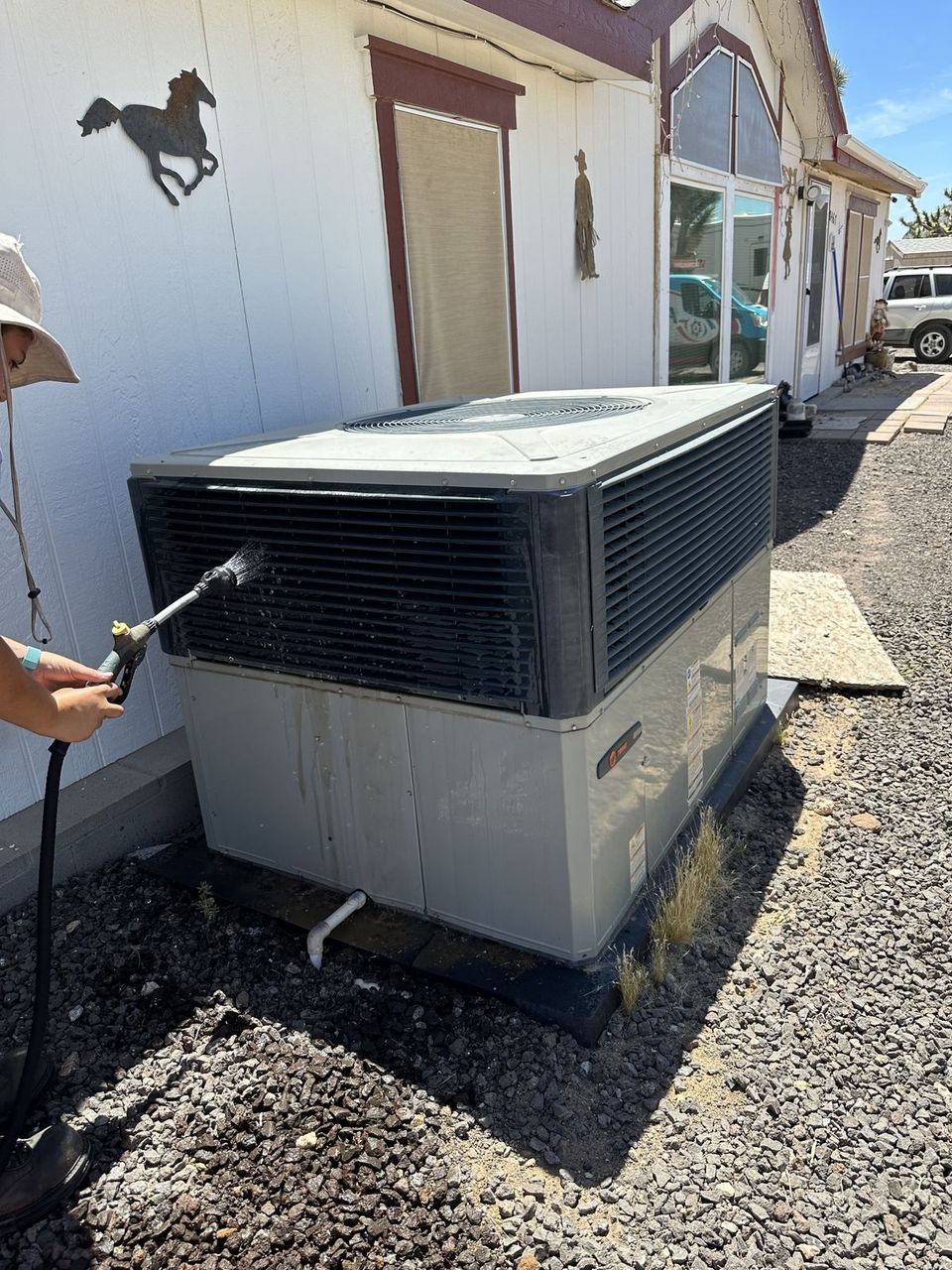 Air-Exx technician washing the coil on a manufactured home package unit