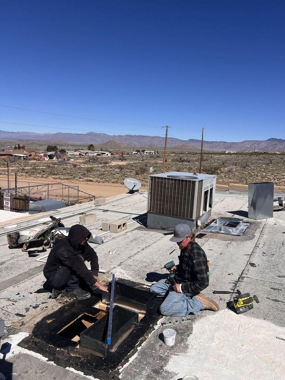 Air-Exx crew cutting in rooftop ductwork in cold weather in northern Arizona