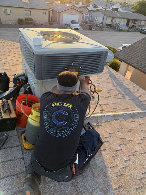 Technician servicing a rooftop package unit