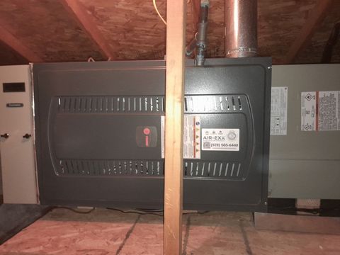 Trane furnace being serviced in an attic
