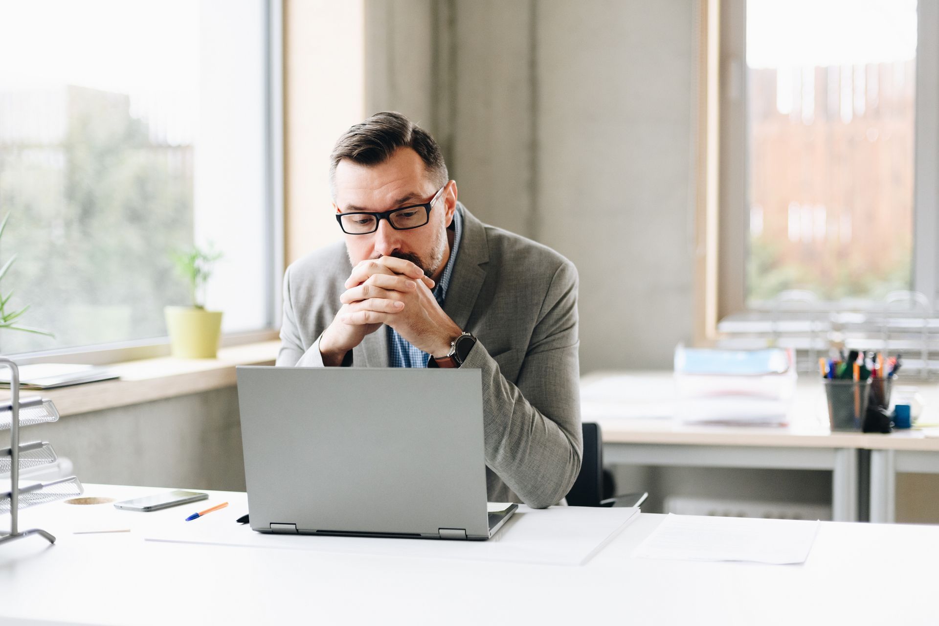 A Man Is Sitting at a Desk in Front of a Laptop Computer | Sydney, NSW | Online Divorce Australia