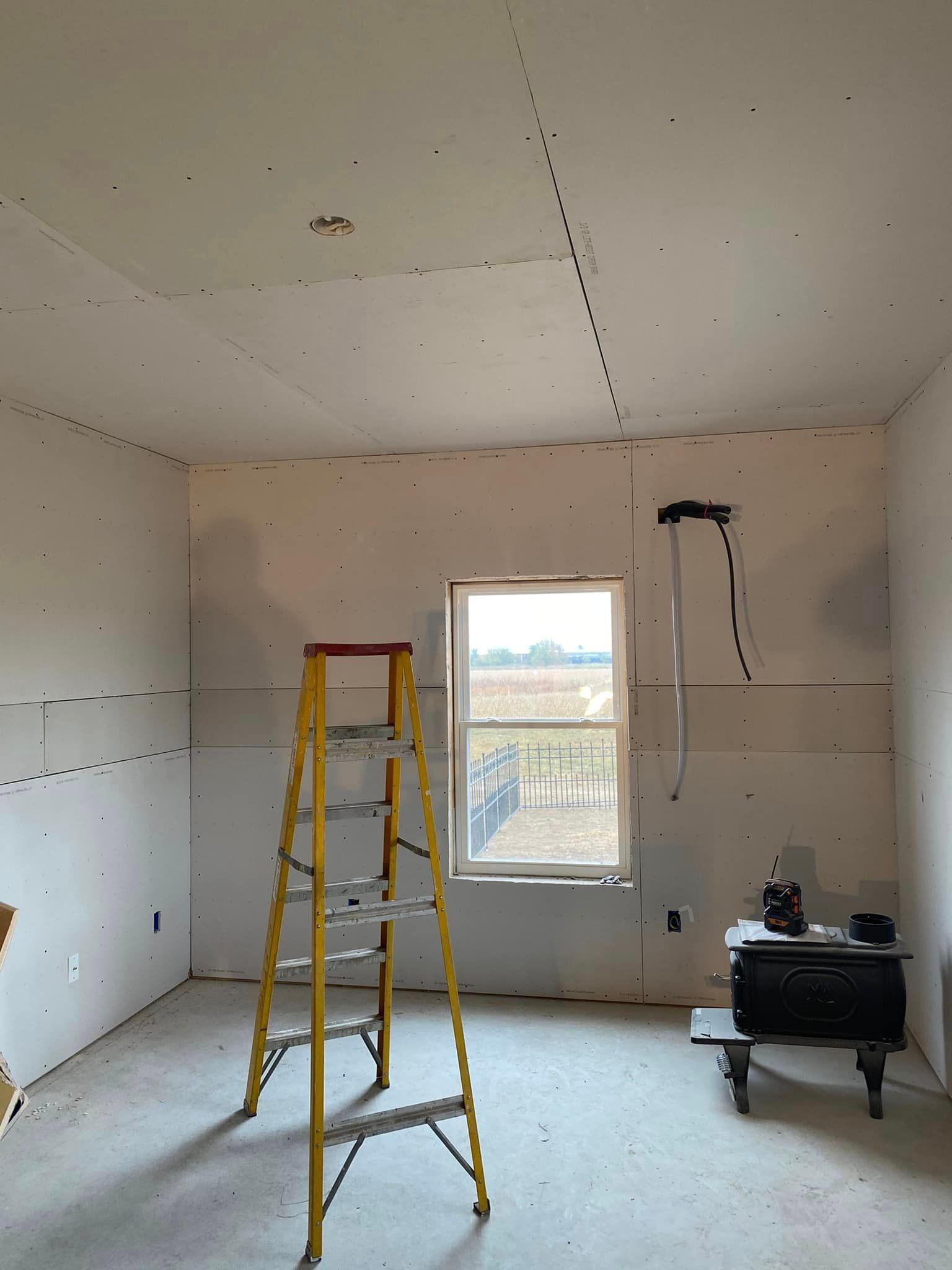 A room with a ladder in the middle of it