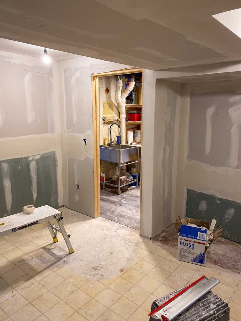 A room with a table and a box in it is being remodeled.