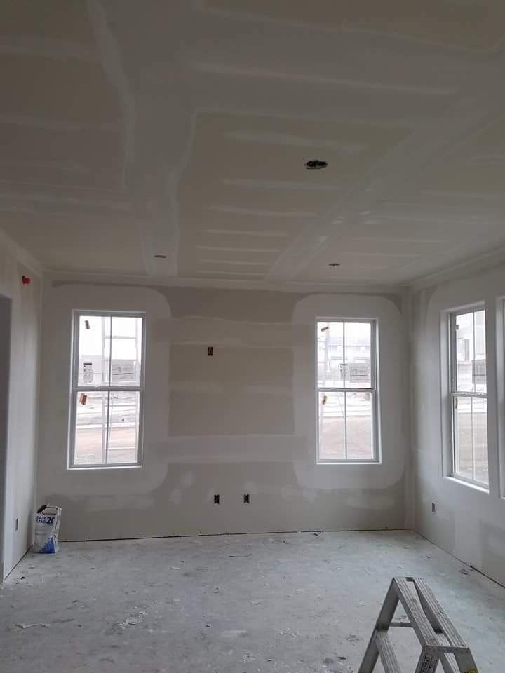A room with a lot of windows and a ladder in it.