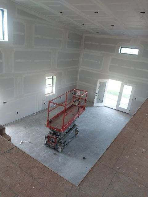 An aerial view of a room with a scissor lift in it.