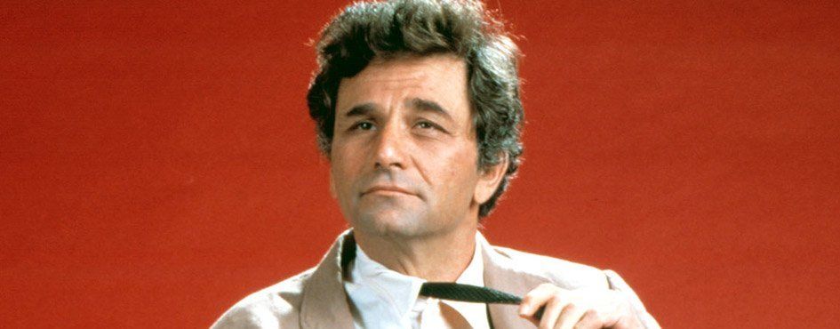 Columbo holding his pen with a red backdrop.